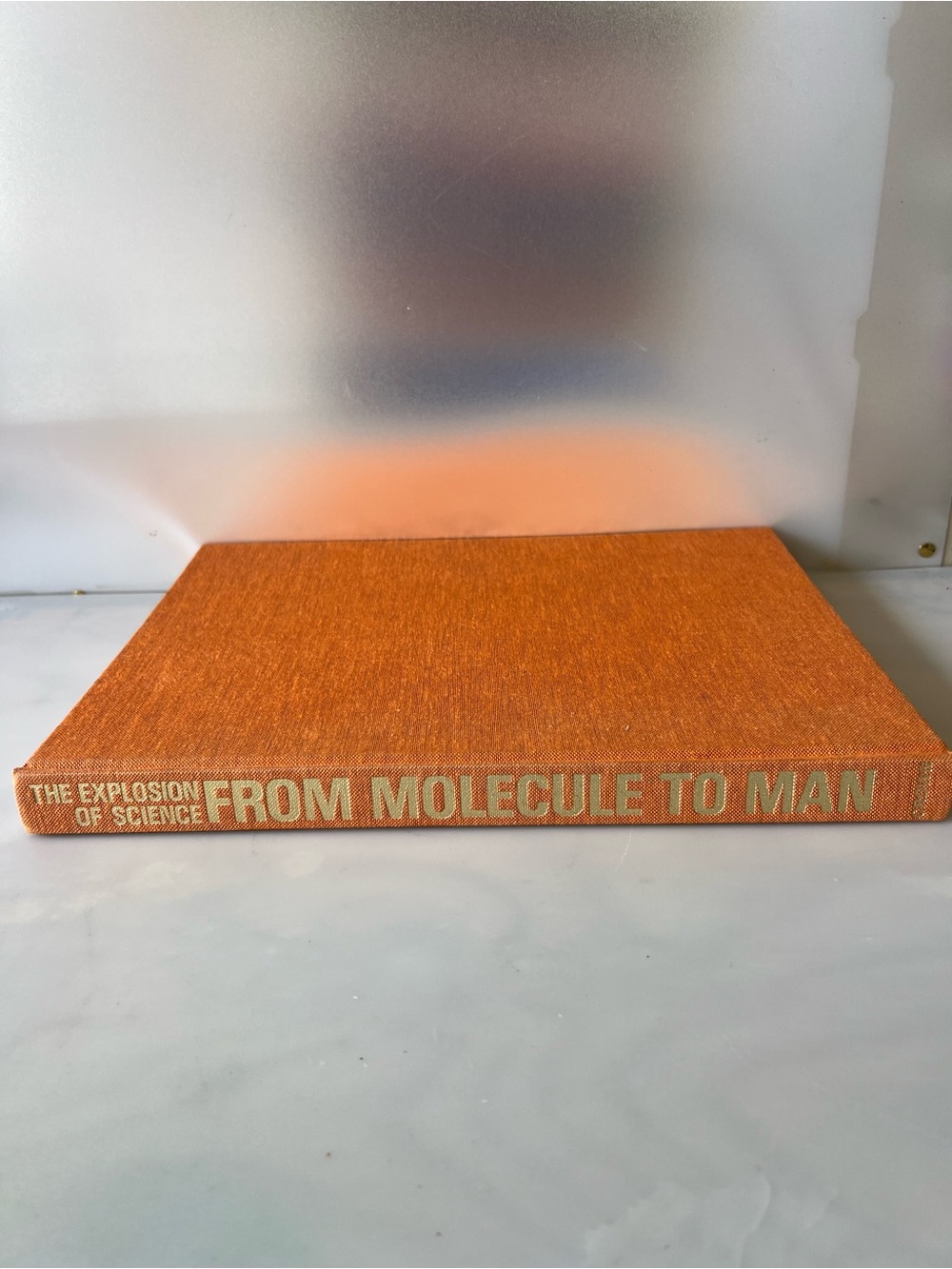 From Molecule to Man Hardcover Book - Orange